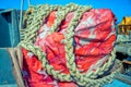 Colorful tarpaulin material and old thick rope Royalty Free Stock Photo